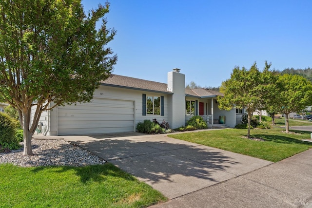 ranch-style home featuring a garage, a chimney, driveway, and a front yard