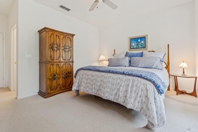 bedroom featuring visible vents, baseboards, a ceiling fan, and light carpet