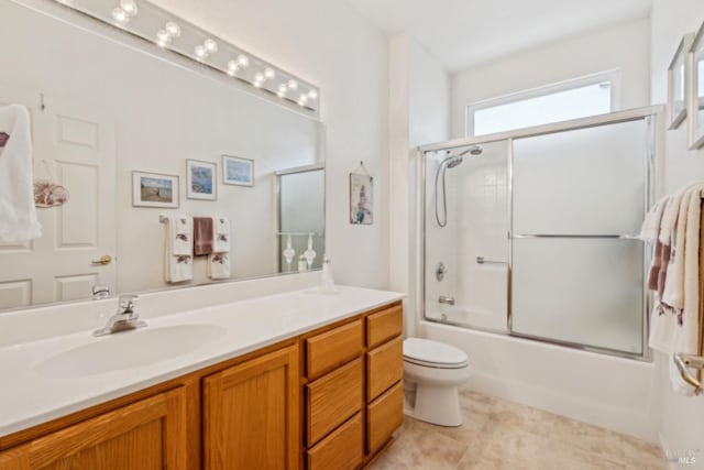 bathroom featuring bath / shower combo with glass door, vanity, and toilet