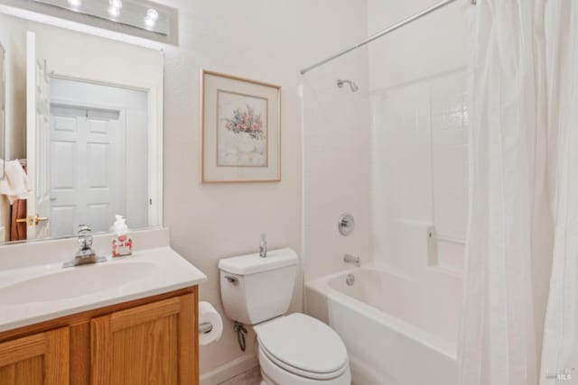bathroom featuring toilet, shower / tub combo, and vanity