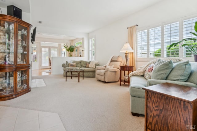living room featuring light colored carpet and visible vents