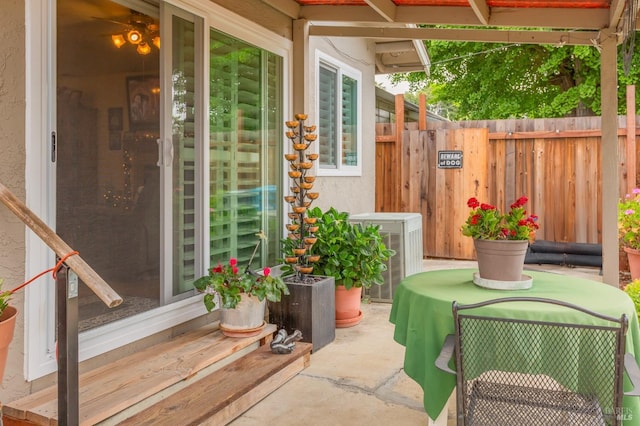view of patio featuring fence and central AC