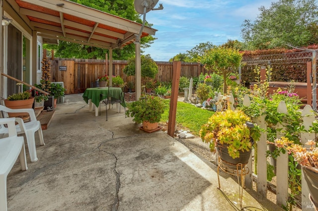 view of patio / terrace with a fenced backyard and a jacuzzi