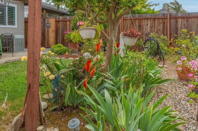 view of yard featuring central AC unit and fence