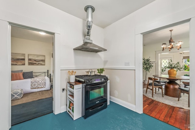 kitchen with a notable chandelier, decorative light fixtures, baseboards, gas stove, and wall chimney range hood