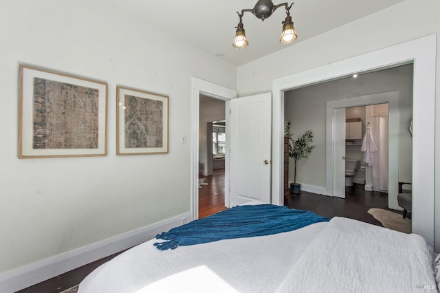 bedroom featuring dark wood-style flooring and baseboards