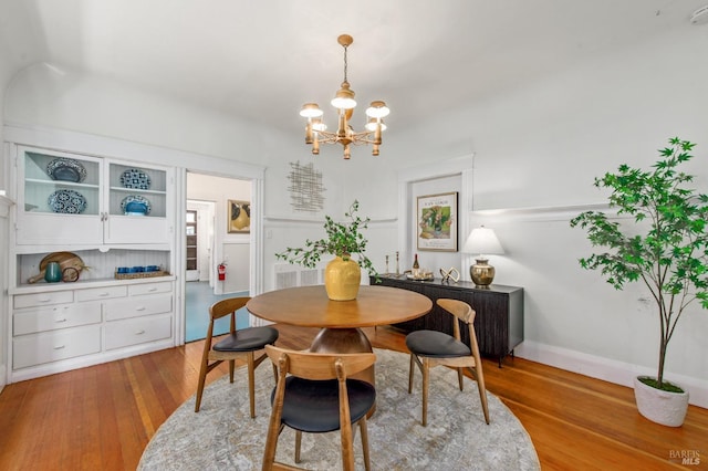 dining space featuring an inviting chandelier and light wood finished floors