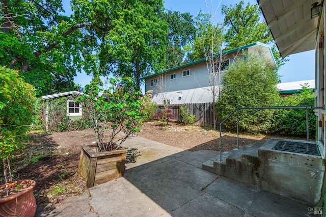 view of yard with fence and a patio