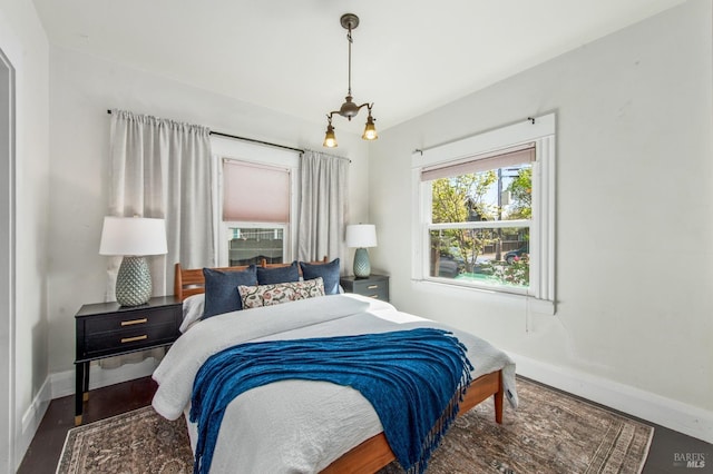 bedroom featuring baseboards and wood finished floors