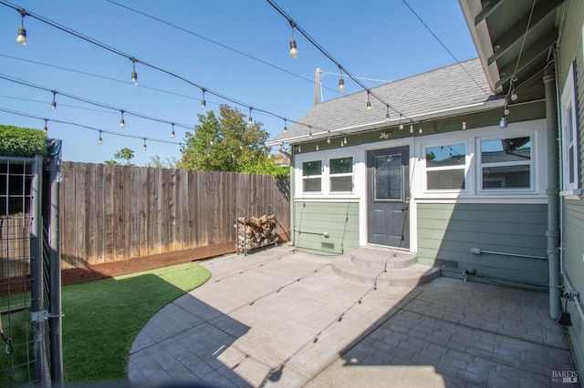 view of patio featuring entry steps and fence