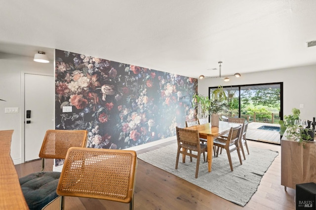 2265 Schaeffer Rd, Sebastopol, CA 95472 - dining space featuring an accent wall, visible vents, wallpapered walls, and wood finished floors