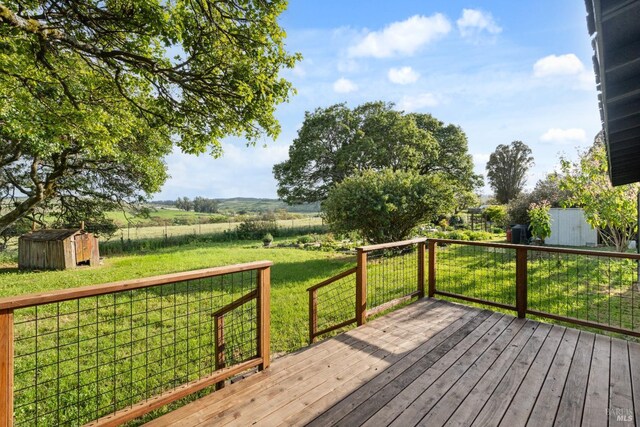 2265 Schaeffer Rd, Sebastopol, CA 95472 - wooden deck featuring a rural view, an outbuilding, a shed, and a lawn