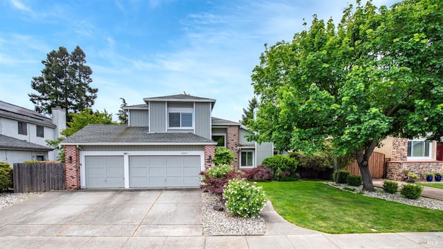 3087 Pecan Cir, Fairfield, CA 94533 - view of front facade with concrete driveway, a front lawn, fence, and brick siding