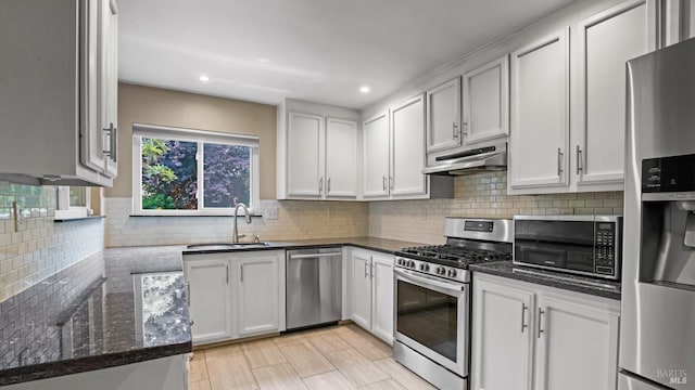 3087 Pecan Cir, Fairfield, CA 94533 - kitchen with a sink, dark stone counters, under cabinet range hood, appliances with stainless steel finishes, and decorative backsplash