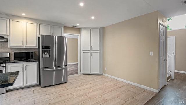 3087 Pecan Cir, Fairfield, CA 94533 - kitchen featuring baseboards, under cabinet range hood, black microwave, stainless steel fridge with ice dispenser, and light wood-style floors