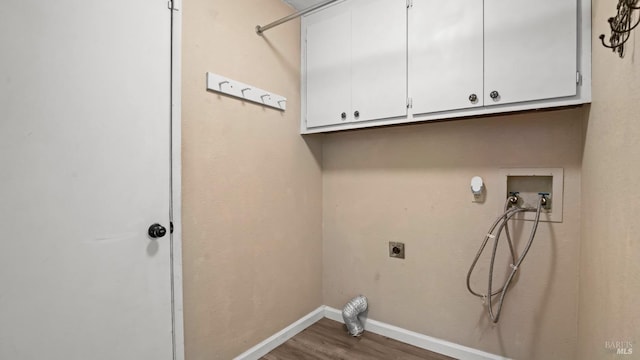 3087 Pecan Cir, Fairfield, CA 94533 - washroom featuring cabinet space, wood finished floors, hookup for an electric dryer, washer hookup, and baseboards