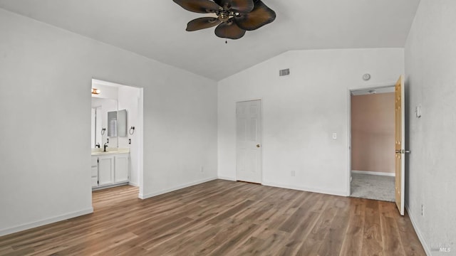 3087 Pecan Cir, Fairfield, CA 94533 - unfurnished bedroom featuring wood finished floors, visible vents, baseboards, ensuite bath, and vaulted ceiling