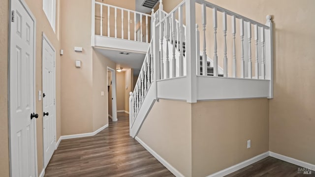 3087 Pecan Cir, Fairfield, CA 94533 - stairway featuring wood finished floors, visible vents, baseboards, and a towering ceiling