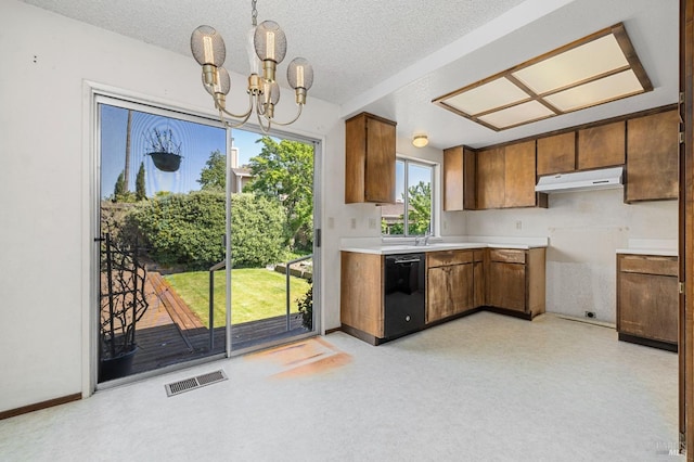 1722 Capella Ct, Petaluma, CA 94954 - kitchen with dishwasher, under cabinet range hood, brown cabinets, a chandelier, and light countertops
