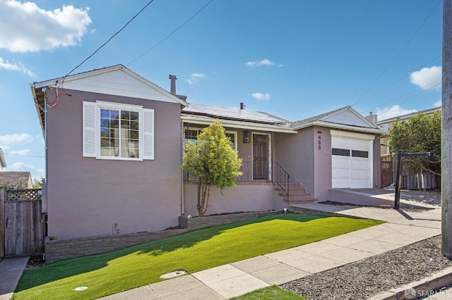 ranch-style home with stucco siding, a garage, solar panels, and concrete driveway