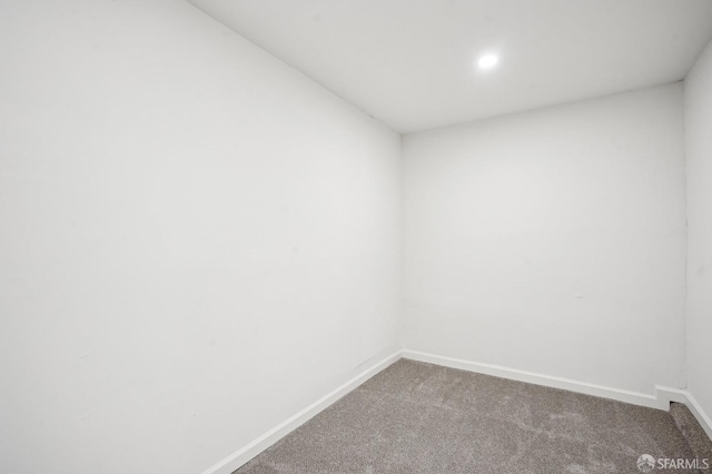 empty room with carpet flooring, baseboards, and recessed lighting