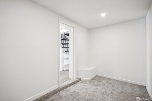 below grade area with carpet flooring, baseboards, and recessed lighting