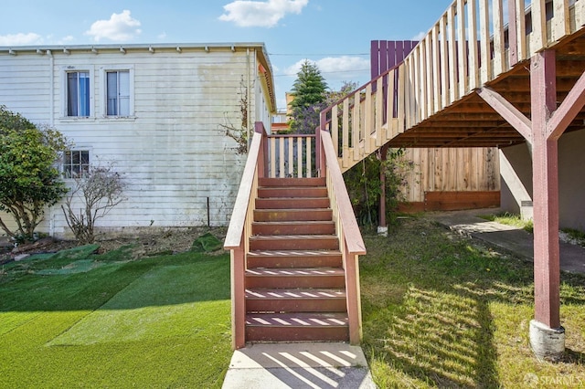 view of green lawn featuring stairs