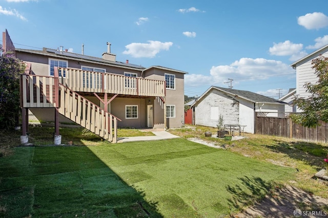 back of house with stairs, a wooden deck, and stucco siding