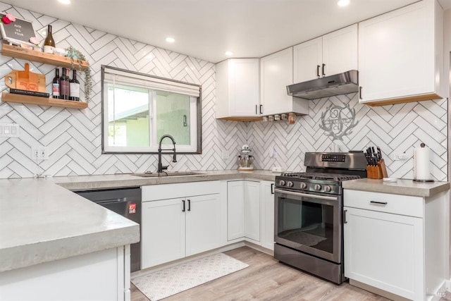 kitchen with a sink, white cabinets, backsplash, under cabinet range hood, and appliances with stainless steel finishes