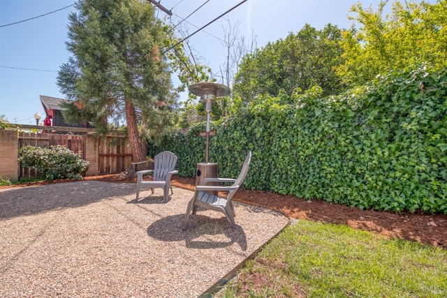 view of yard featuring fence and a patio area
