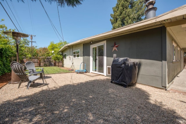 back of property featuring fence and stucco siding