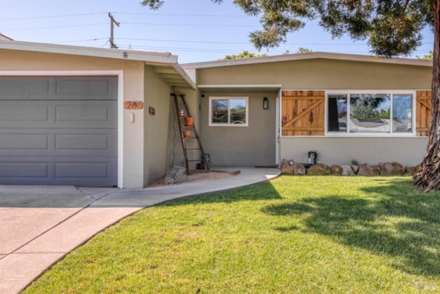 ranch-style house with concrete driveway, stucco siding, a front lawn, and an attached garage