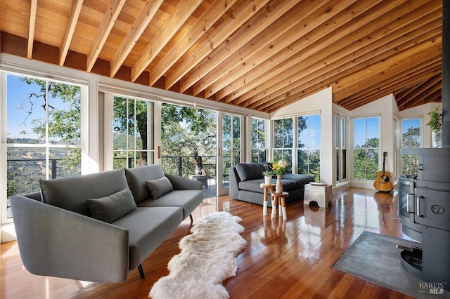 sunroom / solarium featuring vaulted ceiling with beams and wood finished floors