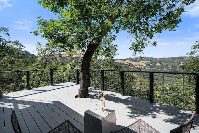 wooden deck with a mountain view