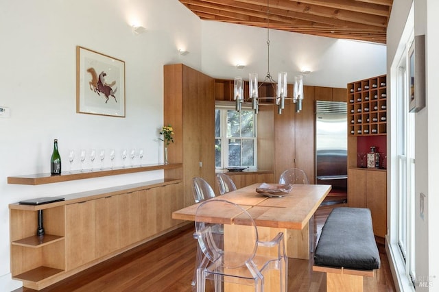 dining space featuring dark wood-style flooring, beamed ceiling, and a notable chandelier