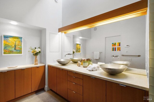 full bathroom with double vanity and a sink