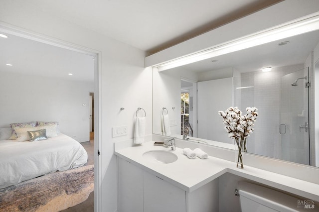 full bathroom with toilet, tiled shower, and vanity