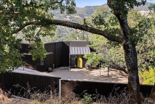 back of house with a mountain view