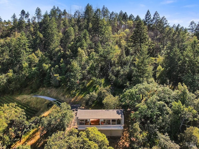birds eye view of property featuring a wooded view