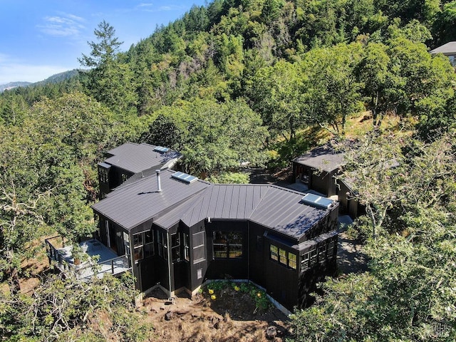 birds eye view of property with a wooded view