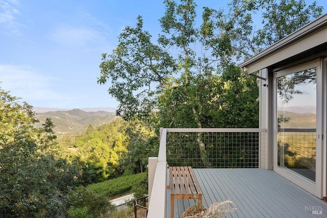 wooden deck with a mountain view