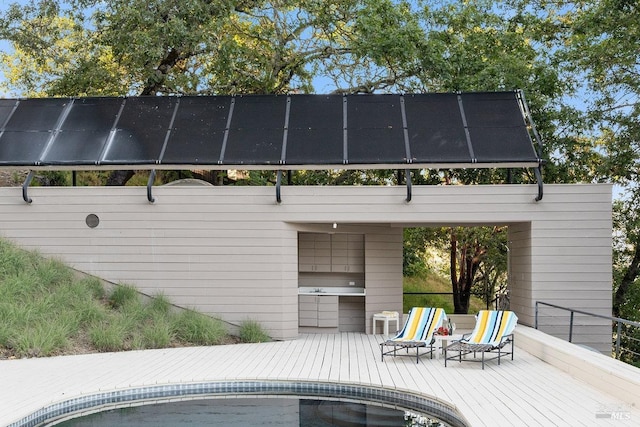 exterior space with an outdoor kitchen and an outdoor pool