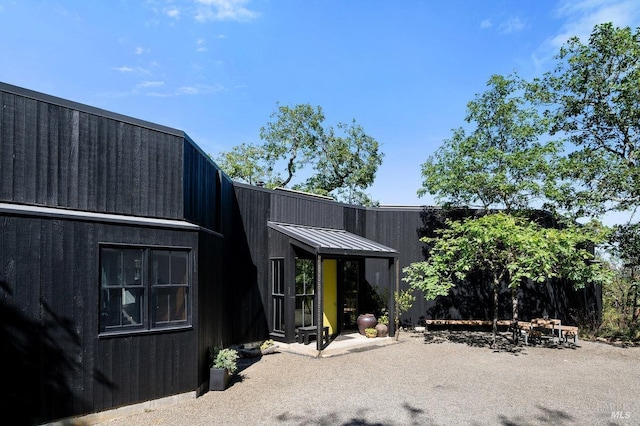back of property with a standing seam roof