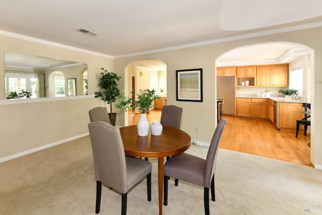 2555 Edgewater Dr, Napa, CA 94558 - dining area with crown molding, visible vents, baseboards, arched walkways, and light colored carpet