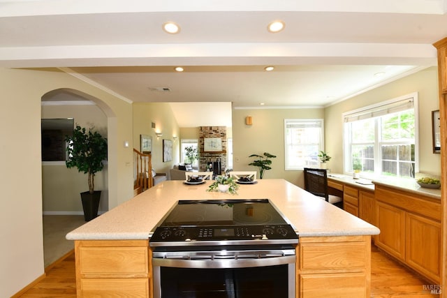 2555 Edgewater Dr, Napa, CA 94558 - kitchen featuring a center island, ornamental molding, light wood finished floors, visible vents, and stainless steel range with electric stovetop