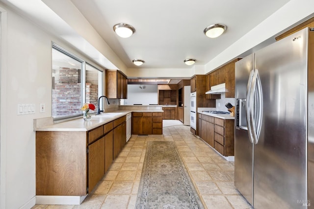 1851 Vallejo St, Saint Helena, CA 94574 - kitchen with a sink, a peninsula, brown cabinetry, white appliances, and light countertops