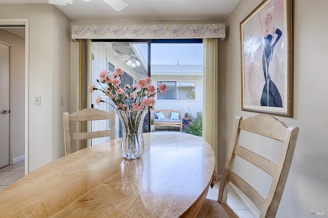 dining area with baseboards and light tile patterned floors