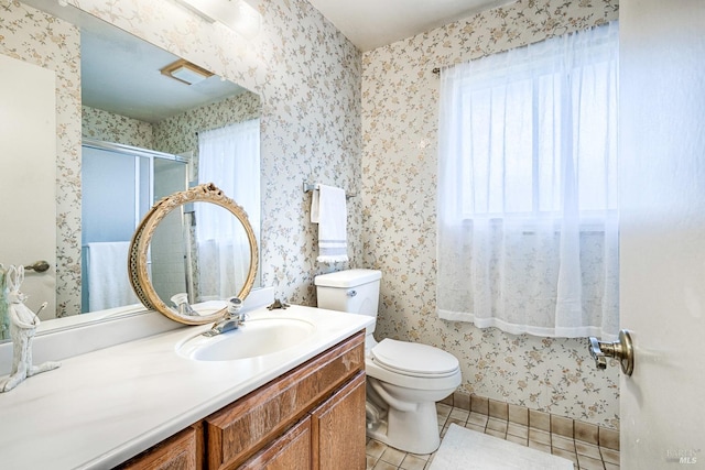 bathroom with tile patterned flooring, toilet, wallpapered walls, and vanity