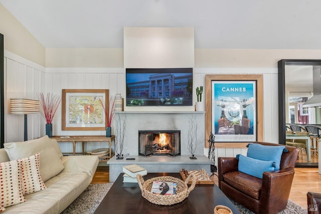 living area with wood finished floors and a fireplace