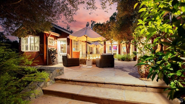 view of patio terrace at dusk